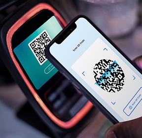 smartphone scans QR code next to reading device